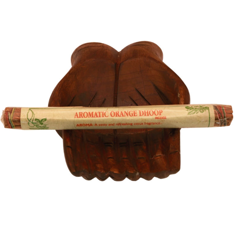 pk of natural tibetan incense on a carved statue of two open hands