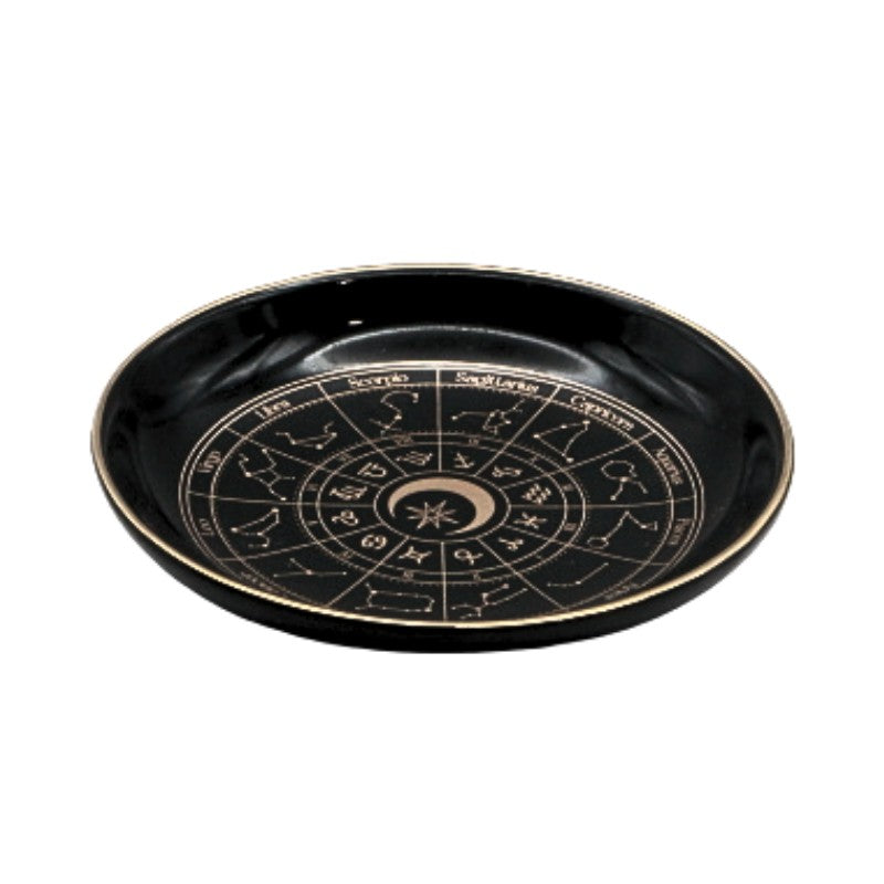 Black plate with zodiac design on a white background