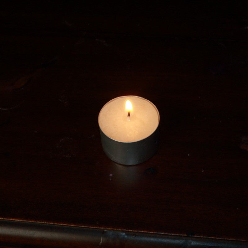 lit beeswax tea light candle