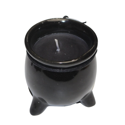 Black wax candle in a black ceramic cauldron