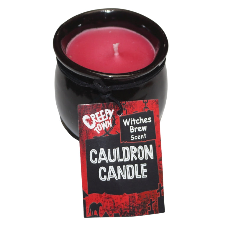 Red wax candle in a black ceramic cauldron
