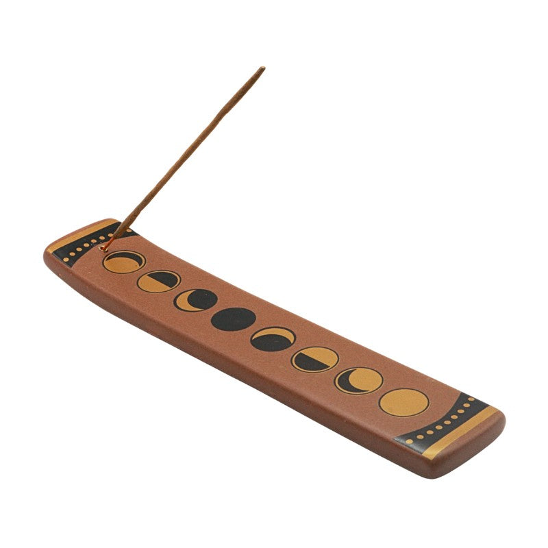 Ceramic incense burner with moon phase design on a white background