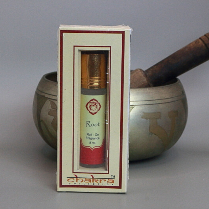 root chakra roll on perfume oil in front of a singing bowl