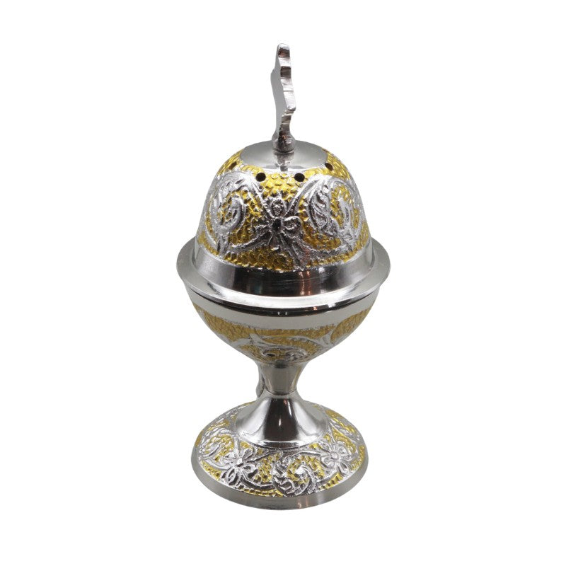 Decorative silver and gold incense burner on a white background