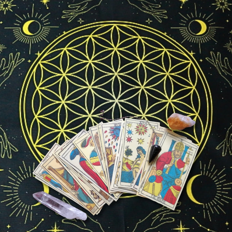 Black and yellow Flower Of Life  Tarot Cloth with tarot cards fanned out on top