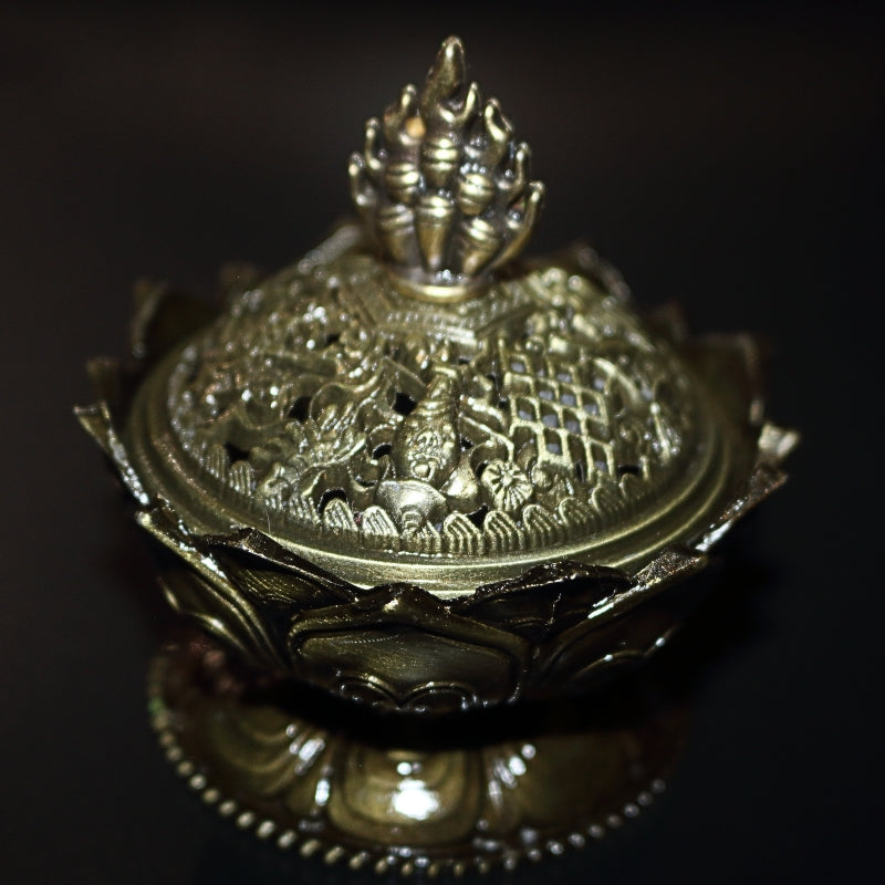 2 piece gold coloured ornate incense holder / censer on a black background