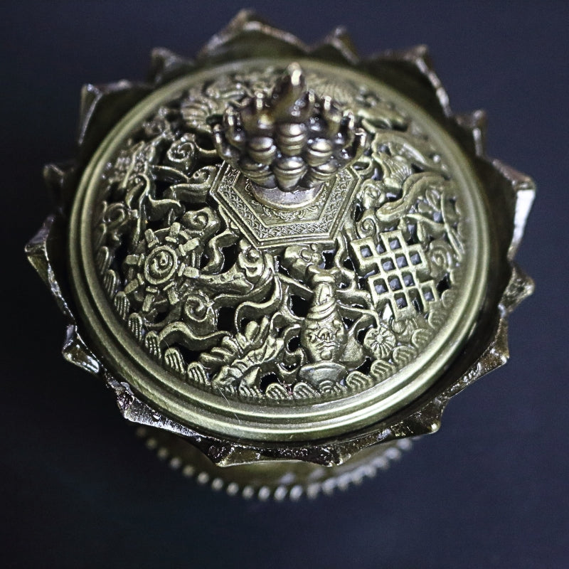 top view of a 2 piece gold coloured ornate incense holder / censer on a black background