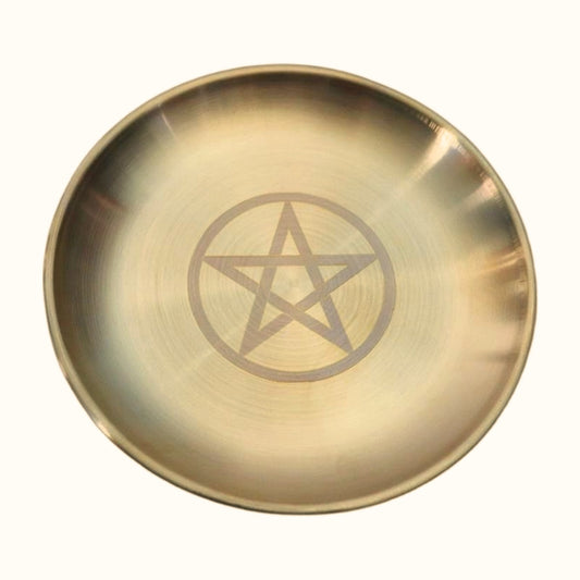 gold coloured altar plate with a pentacle (5 pointed star within a circle) etched on the front