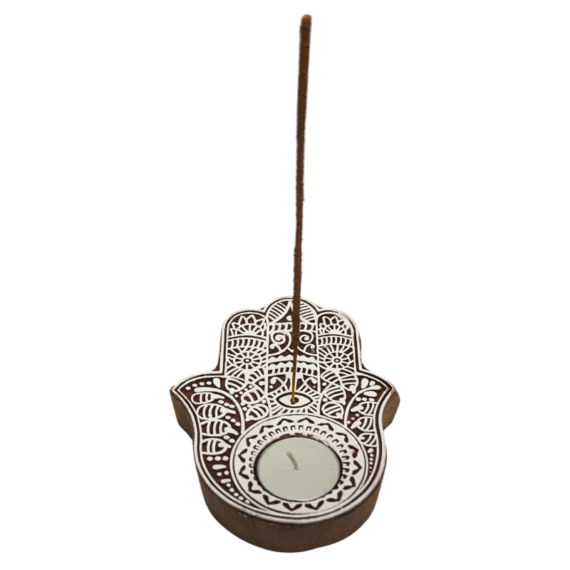 White patterned hamsa hand tealight and incense holder with a tealight candle and incense stick