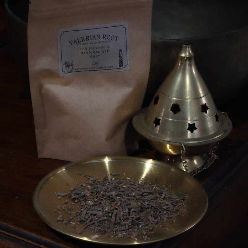 Valerian root packaging with a brass dish containing valerian root and a brass cone incense burner.