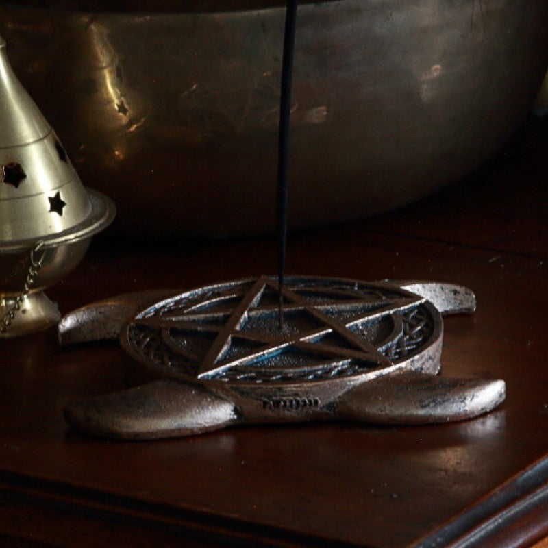 incense stick in Pentacle Incense Burner  on a wooden table