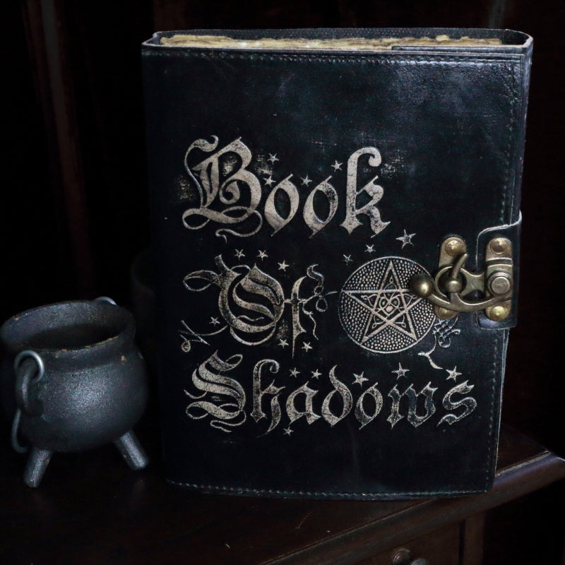 book of shadows journal next to a baby cauldron