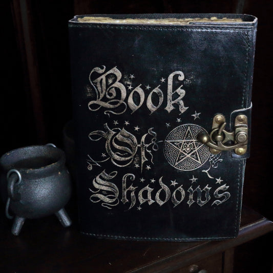 book of shadows journal next to a baby cauldron