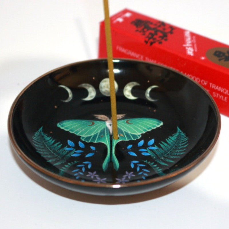 luna moth incense dish in front of a box of japanese incense