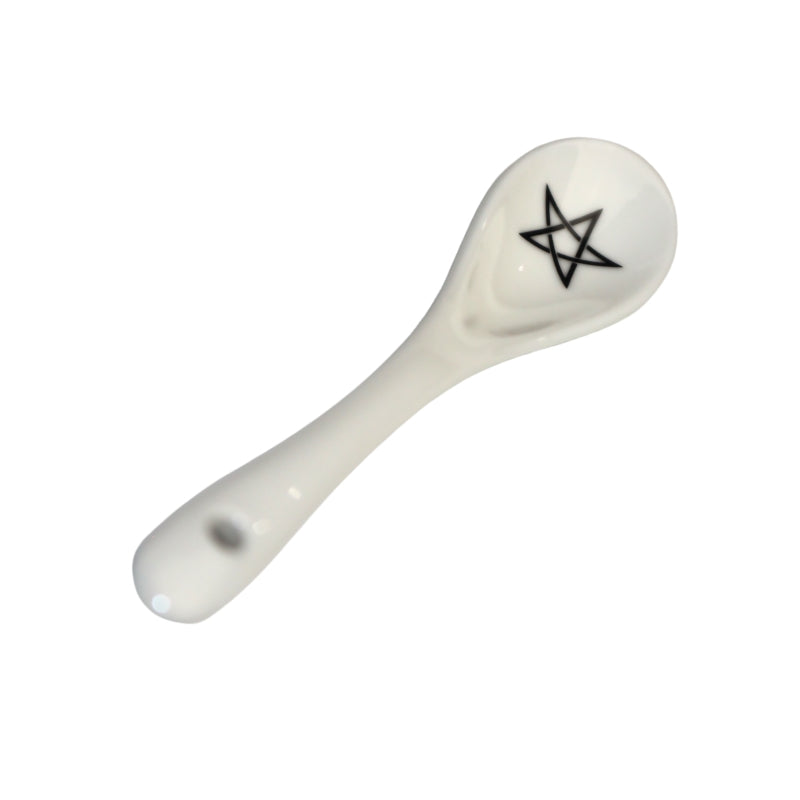  white spoon  with a black pentagram drawn in the bowl of the spoon
