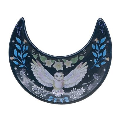Decorative plate with an owl design and floral designs on a white background
