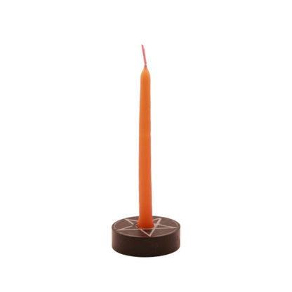 orange  tiny taper candle in a pentacle candle holder