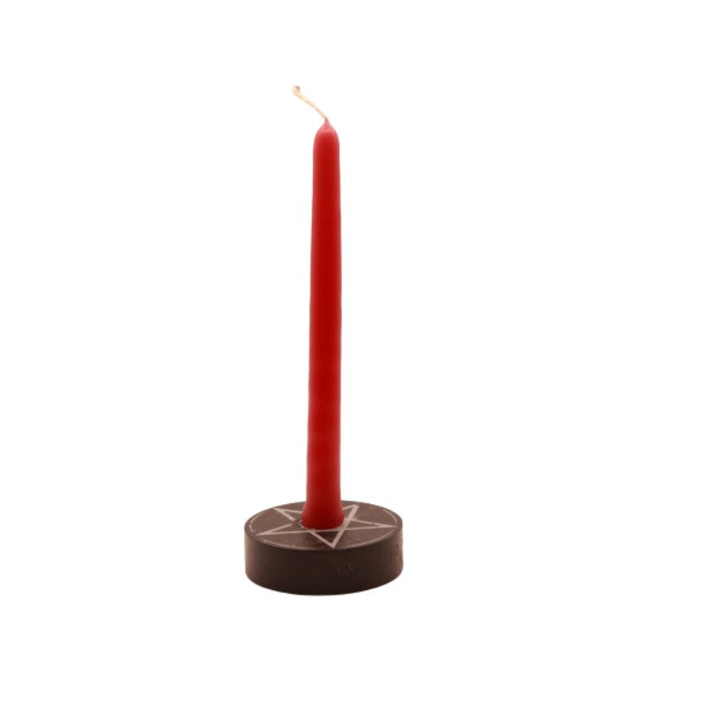 red tiny taper candle in a pentacle candle holder