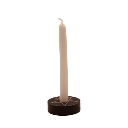 white  tiny taper candle in a pentacle candle holder
