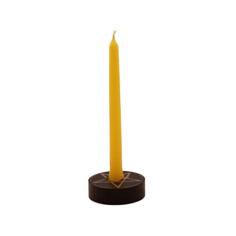 yellow  tiny taper candle in a pentacle candle holder