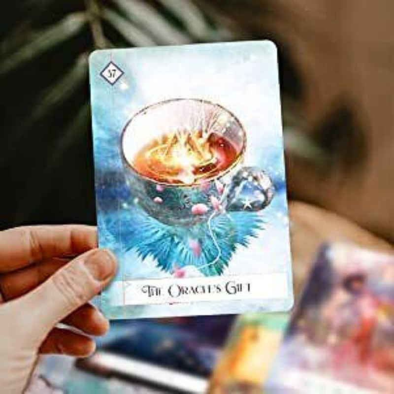 person holding a card from Oracle of the 7 Energies