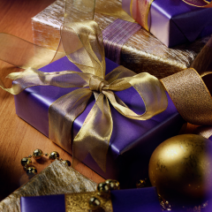 purple and gold christmas gift with gold christmas baubles