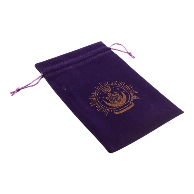 purple velvet bag with gold crystal ball image on front