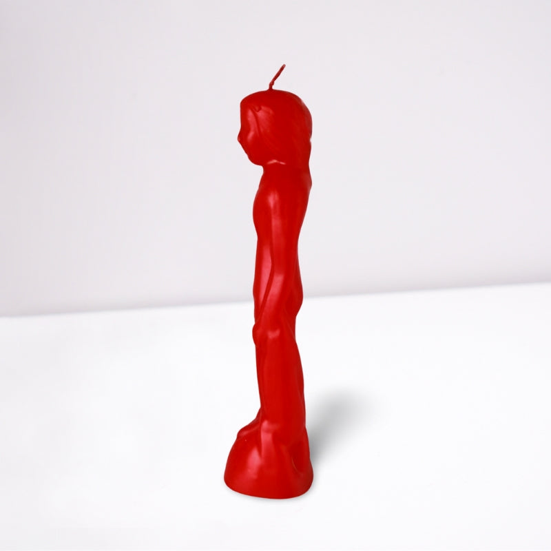 red naked figure candle in the shape of a naked male- side view- on a white background