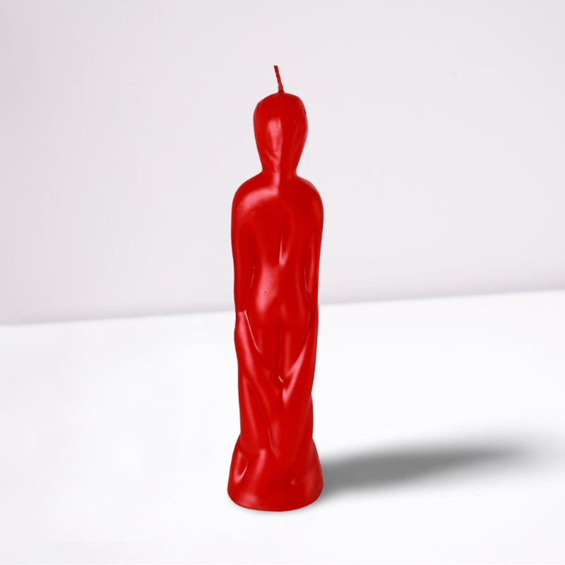 red naked figure candle in the shape of a naked male- back view- on a white background