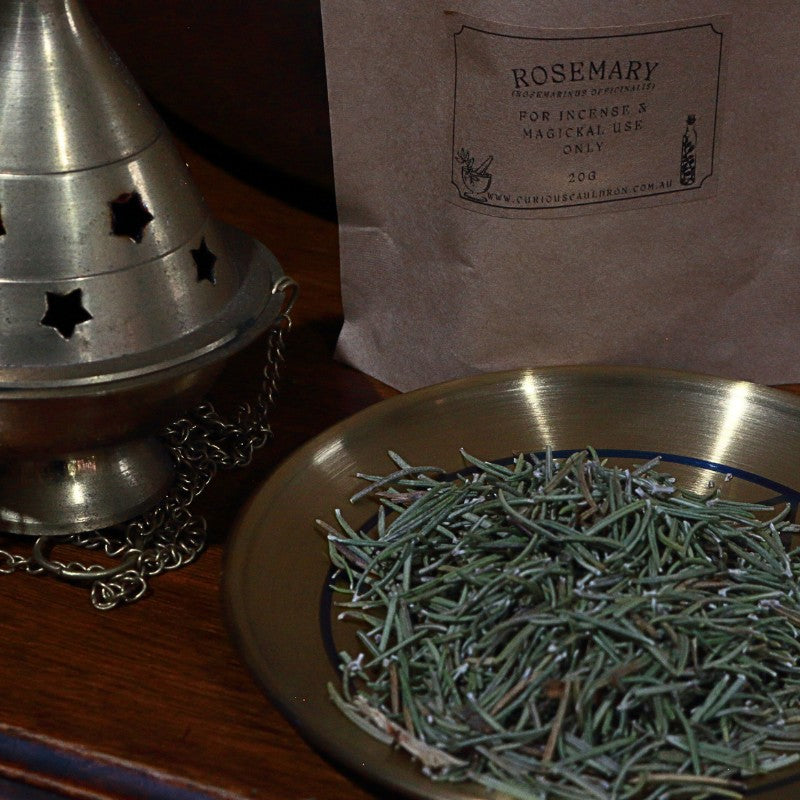Rosemary incense on a plate with a packaging bag labeled 'Rosemary' in the background.