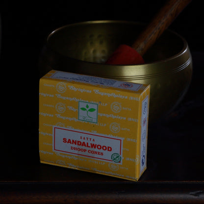 box of satya brand incense cones in front of a brass singing bowl