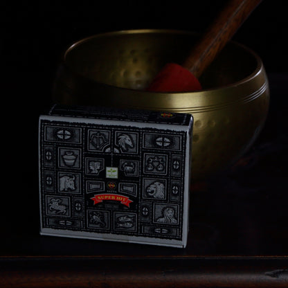 box of satya brand incense cones in front of a brass singing bowl