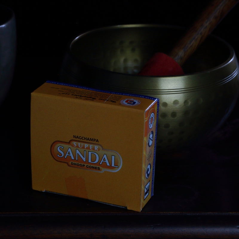 box of satya brand incense cones in front of a brass singing bowl