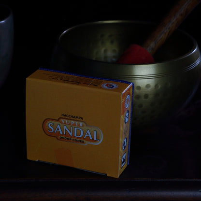 box of satya brand incense cones in front of a brass singing bowl