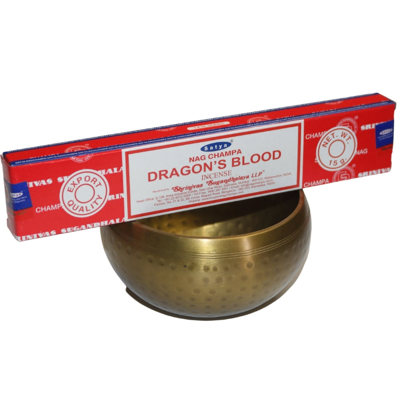 Red and white Box of  Satya dragon's blood incense  sitting on a brass singing bowl
