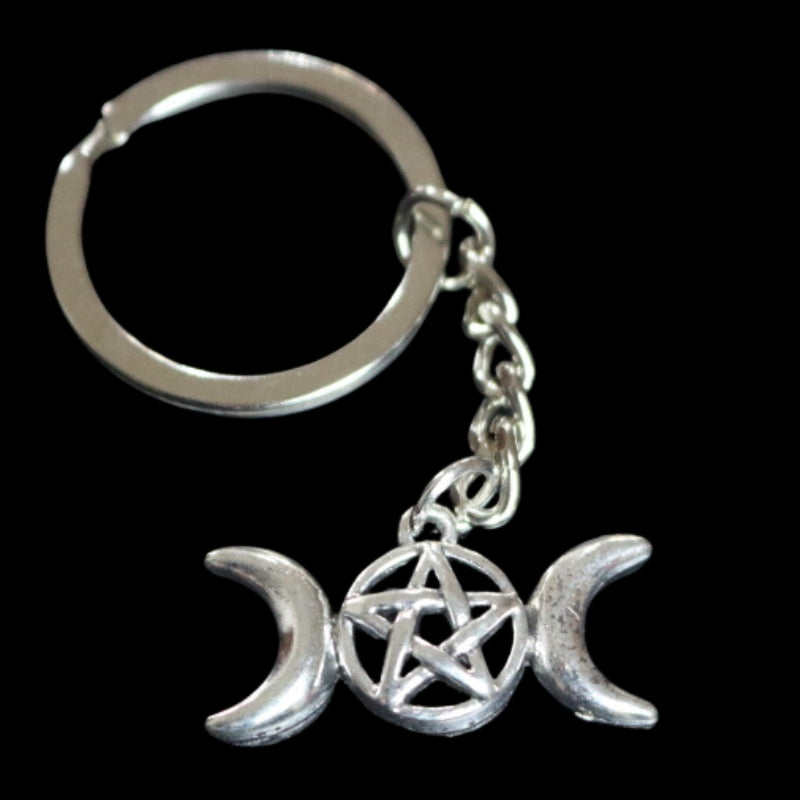 silver coloured key ring with a triple moon (a crescent moon on either side of a circle) with a  pentagram inside the circle (5 pointed star within a circle) joined to a silver ring by a silver chain