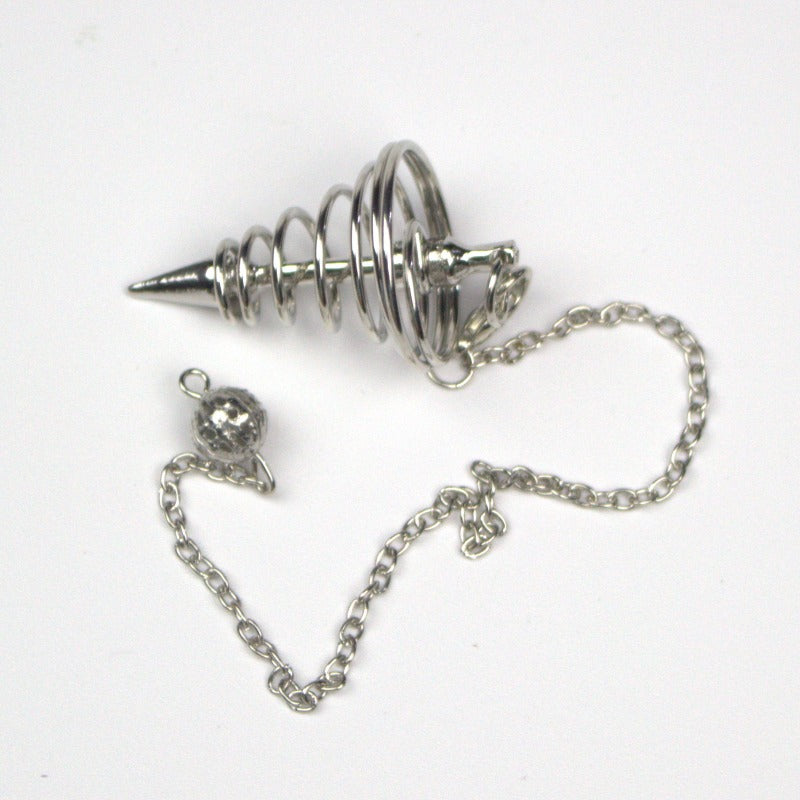 silver spiral pendulum sitting on a black background