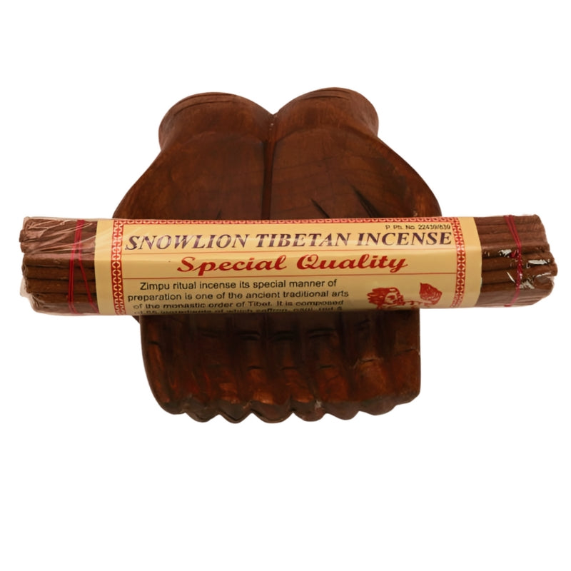 pk of hand rolled "SNOWLION" tibetan incense sitting on a statue of carved wooden hands