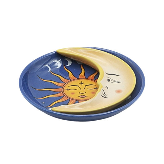 Ceramic plate with sun and moon design on a white background