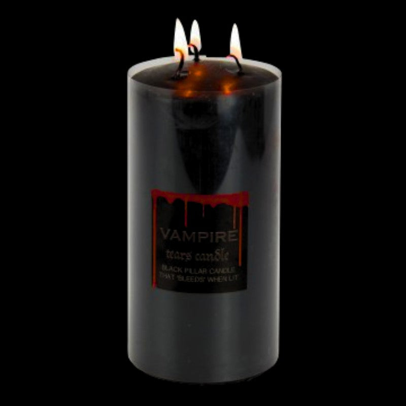 lit  black pillar candle that bleeds red wax when lit