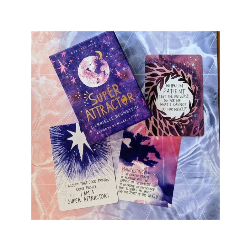 super attractor tarot cards laid out on pink and blue scarf with box