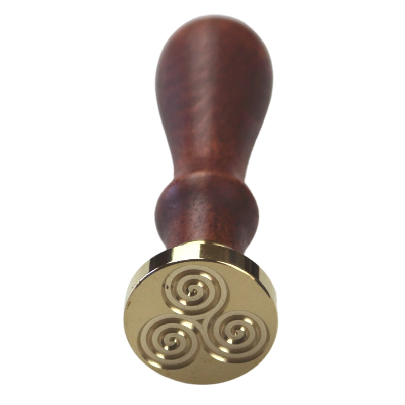 Brass wax seal stamp of a triskele on a wooden handle