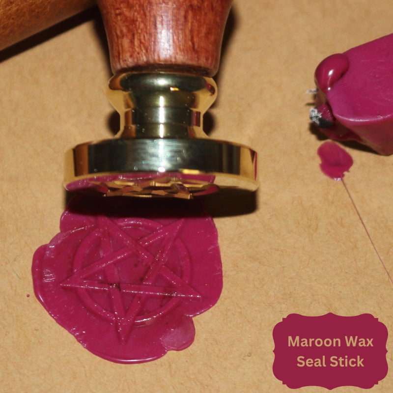 maroon wax seal on brown paper with wax seal stamp and sealing wax