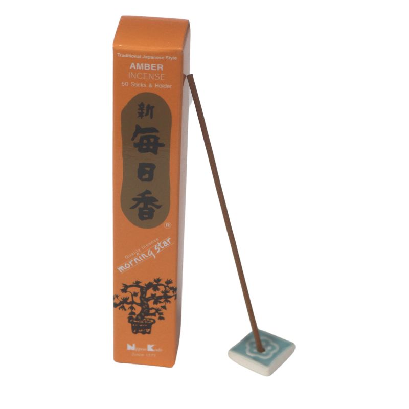rectangle box of japanese morning star "amber" incense sticks next to a tile with incense stick