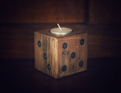 wooden square dice candle with white tea light candle on wooden background