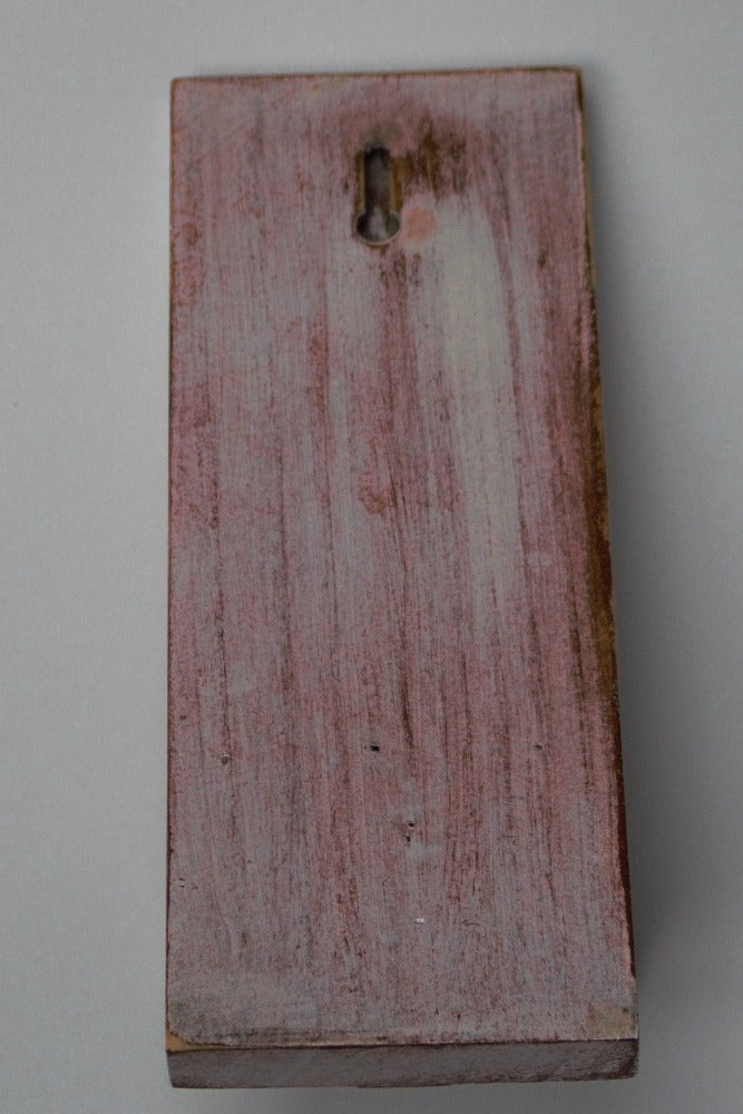 back view of red and white wooden wall mounted candle or ornament  shelf  showing the keyhole for mounting