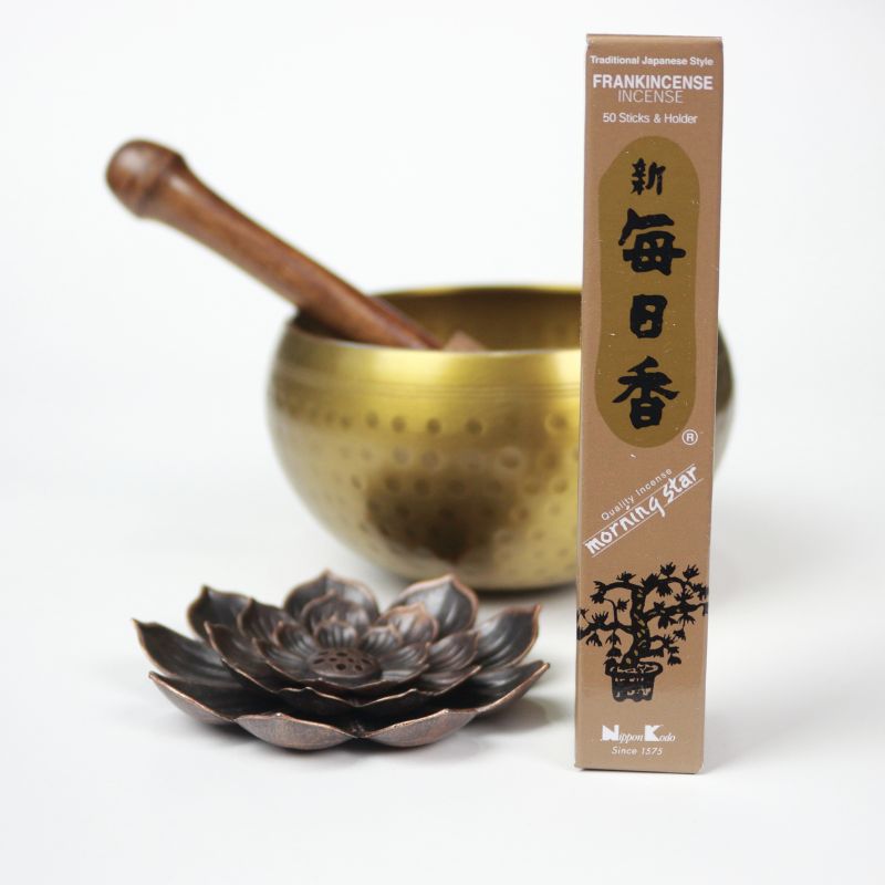 rectangle box of japanese morning star "frankincense" incense sticks next to a lotus incense holder and brass singing bowl
