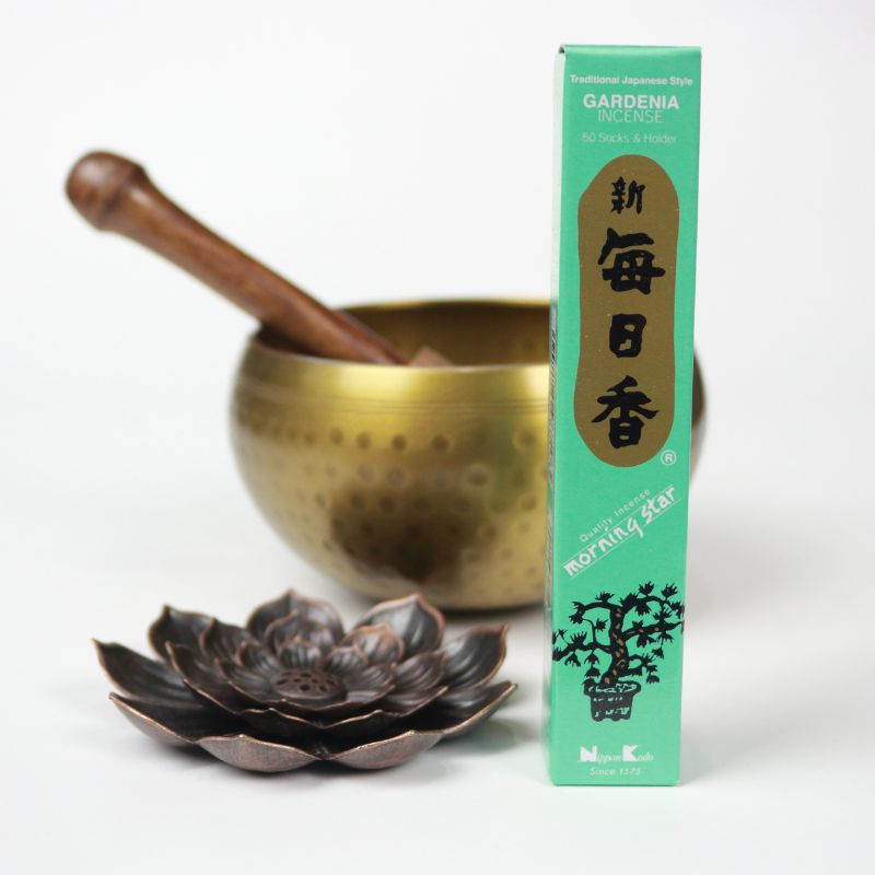 rectangle box of japanese morning star "gardenia" incense sticks next to a lotus incense holder and brass singing bowl