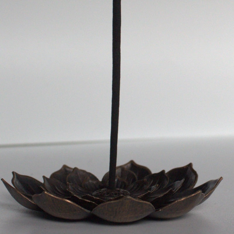 lotus flower incense holder with incense stick, sitting on  white background