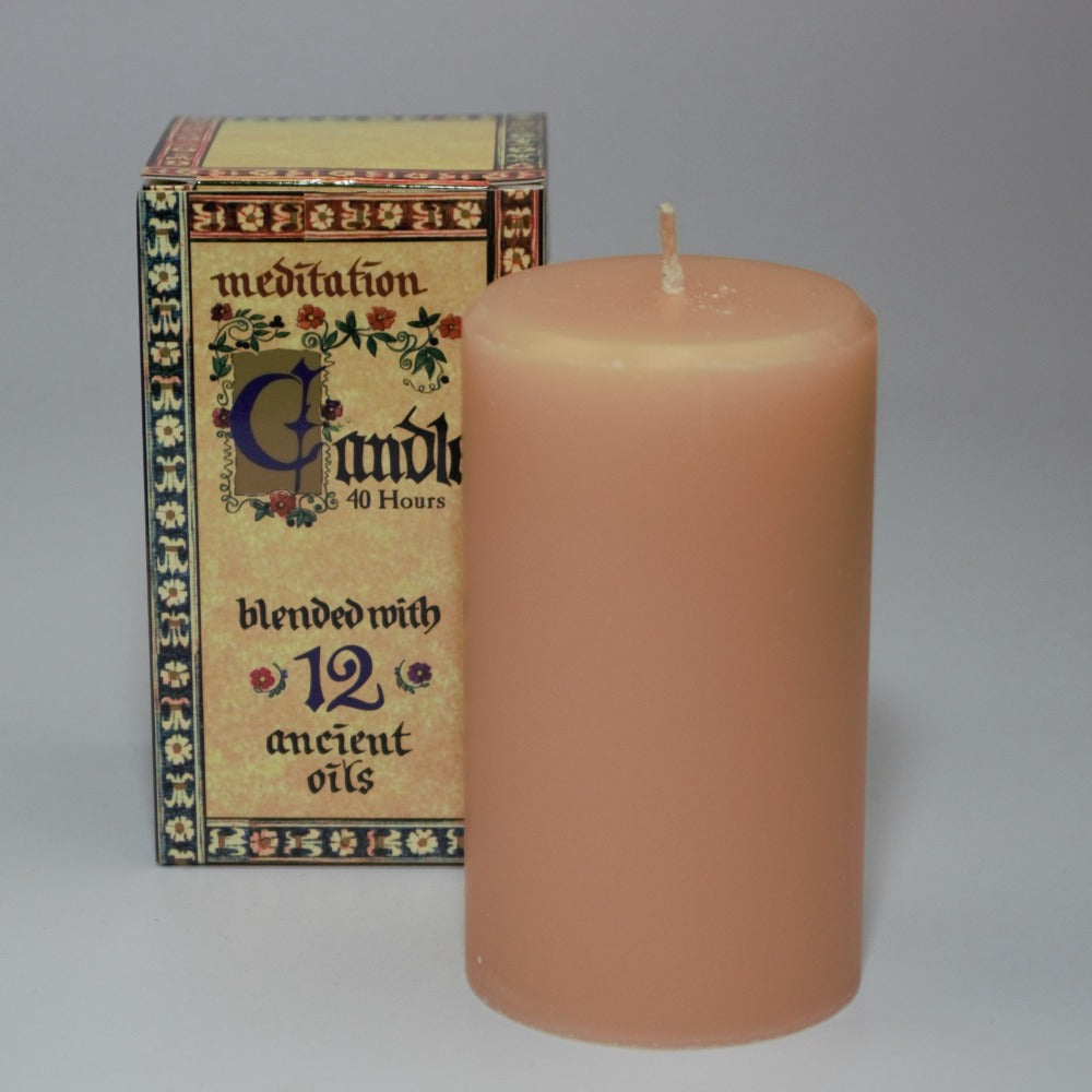 meditation candle 40 hour burn time, sitting  in front of  its packaging box, on a white background